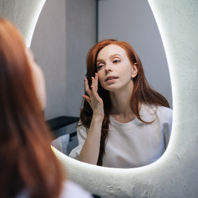 Irregular egg-shaped wall-mounted mirror with LED backlighting