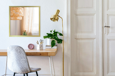 Decorative rectangular wall mirror with a gold frame