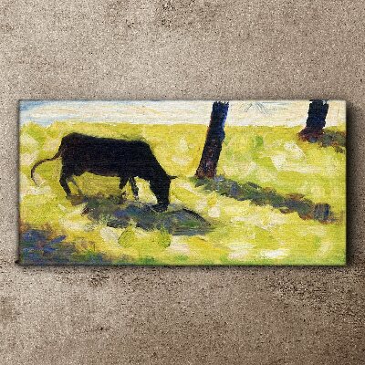 A cow grazing in a green landscape Print on canvas