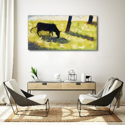 A cow grazing in a green landscape Print on canvas