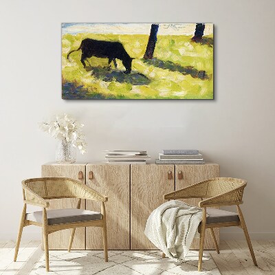 A cow grazing in a green landscape Print on canvas