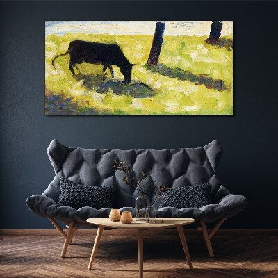A cow grazing in a green landscape Print on canvas