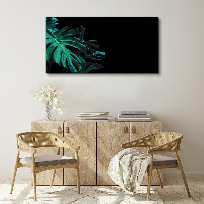 Green leaves on a black background Print on canvas