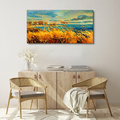 Golden grass over blue water Canvas wall art