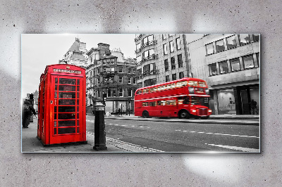 Red telephone in a grey city Wall art on glass