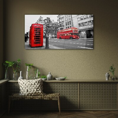 Red telephone in a grey city Wall art on glass