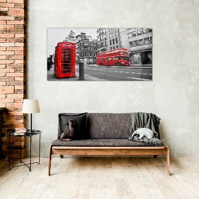 Red telephone in a grey city Wall art on glass