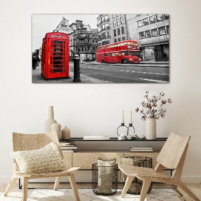 Red telephone in a grey city Wall art on glass