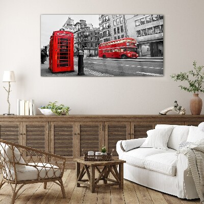 Red telephone in a grey city Wall art on glass