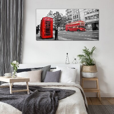 Red telephone in a grey city Wall art on glass