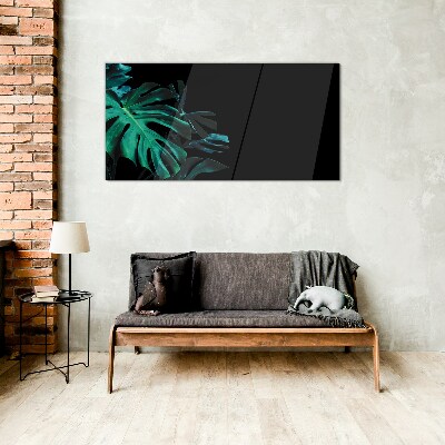 Green leaves on a black background Glass art print