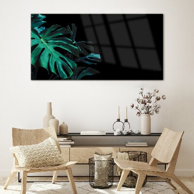 Green leaves on a black background Glass art print