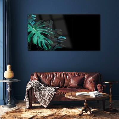 Green leaves on a black background Glass art print