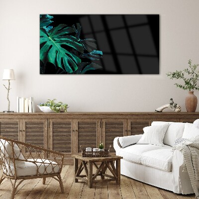 Green leaves on a black background Glass art print