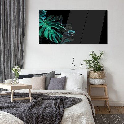 Green leaves on a black background Glass art print