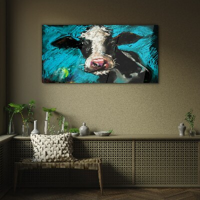 Portrait of a cow on a blue background Glass art print