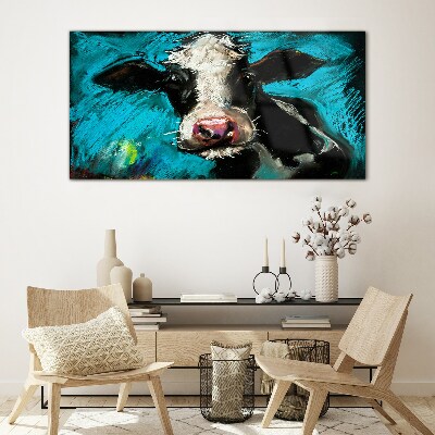 Portrait of a cow on a blue background Glass art print