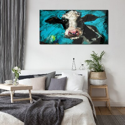 Portrait of a cow on a blue background Glass art print