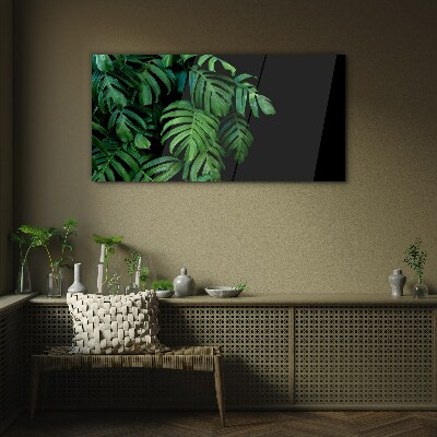 Green leaves on a black background Glass art print