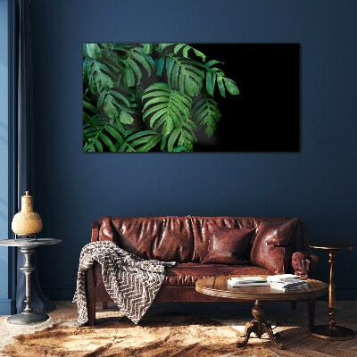 Green leaves on a black background Glass art print