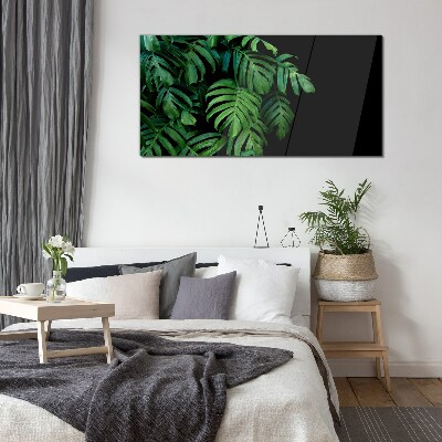 Green leaves on a black background Glass art print
