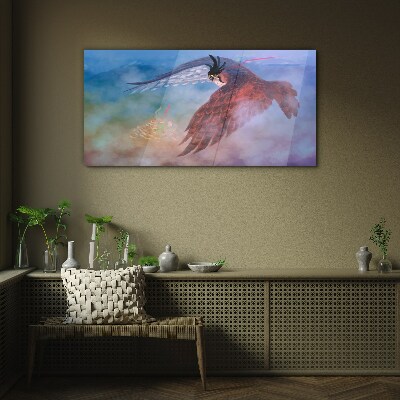 Flight of a bird of prey in the clouds Glass art print