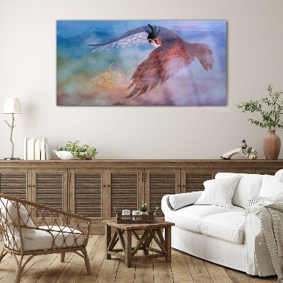 Flight of a bird of prey in the clouds Glass art print