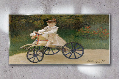 Child on a ride-on Glass art print