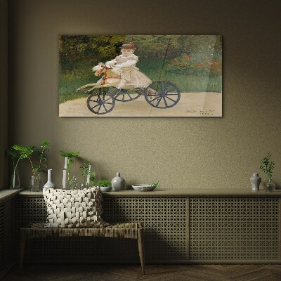 Child on a ride-on Glass art print