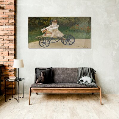 Child on a ride-on Glass art print