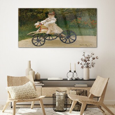 Child on a ride-on Glass art print