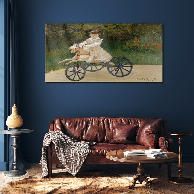 Child on a ride-on Glass art print
