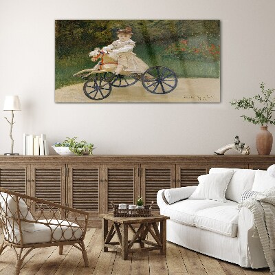 Child on a ride-on Glass art print