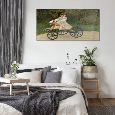 Child on a ride-on Glass art print