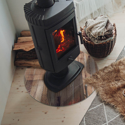 Glass hearth for stove round Wooden board in arrangement