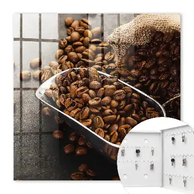 Key cabinet Coffee beans in a metal ladle