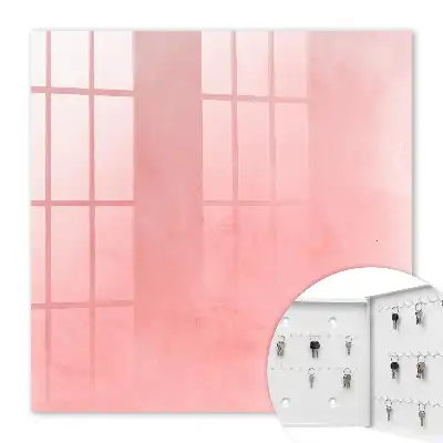 Wall mounted key cabinet Pink background with a subtle pattern