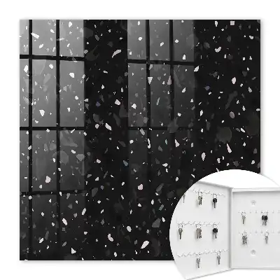 Wall mounted key cabinet Black terrazzo in the background