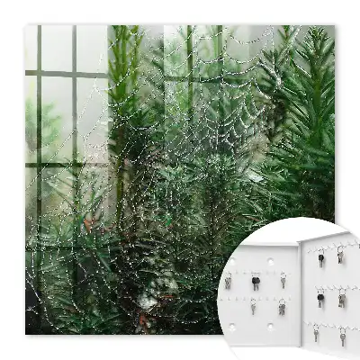 Decorative key box A spider's web in a forest of green needles