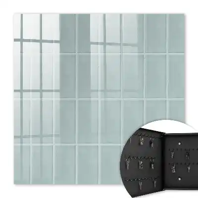 Wall mounted key cabinet Blue tiles in muted tones