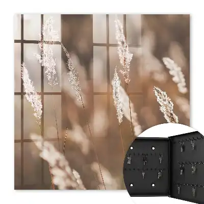 Wall mounted key box Grasses in the meadow in the background blur